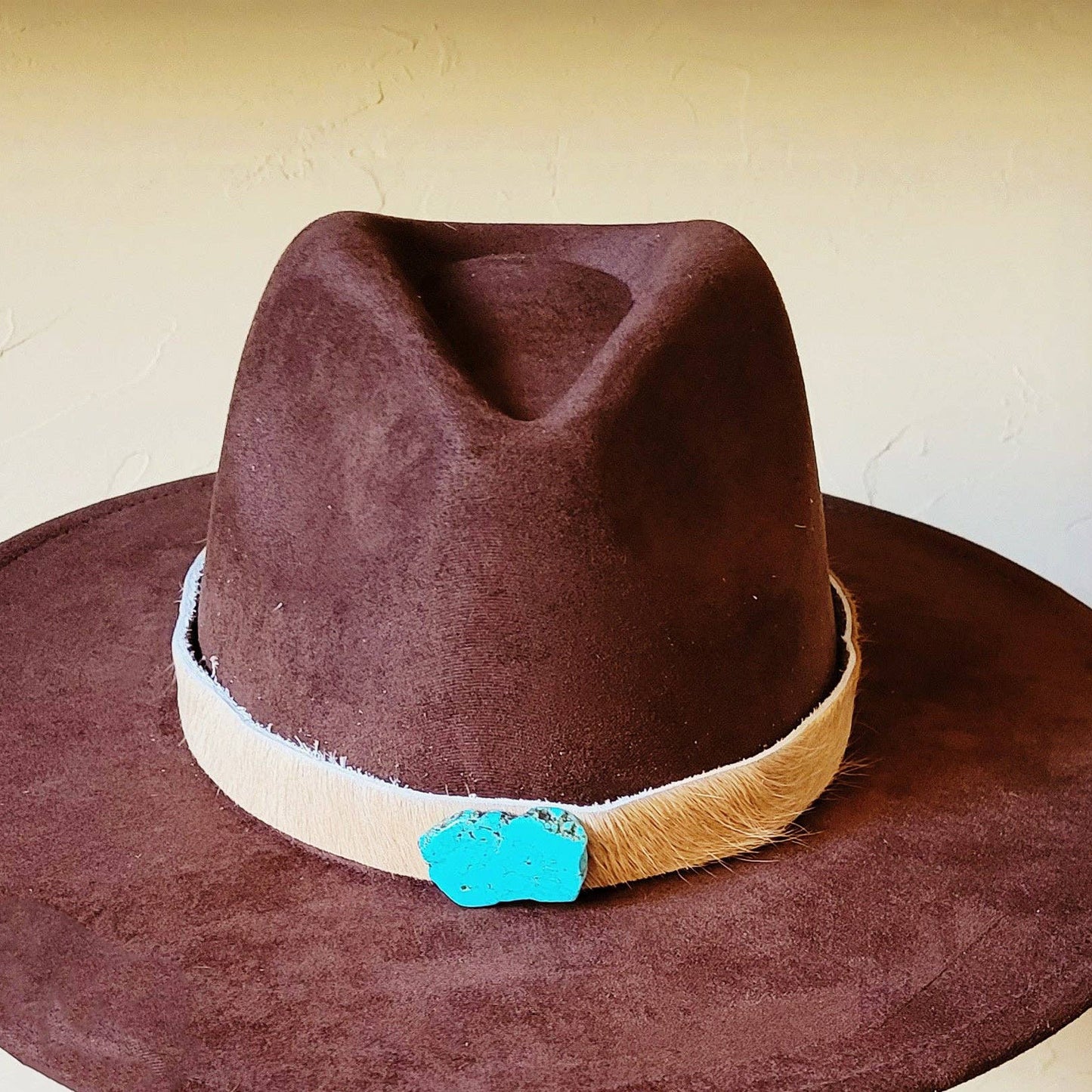 Brown cowboy hat with turquoise accent.