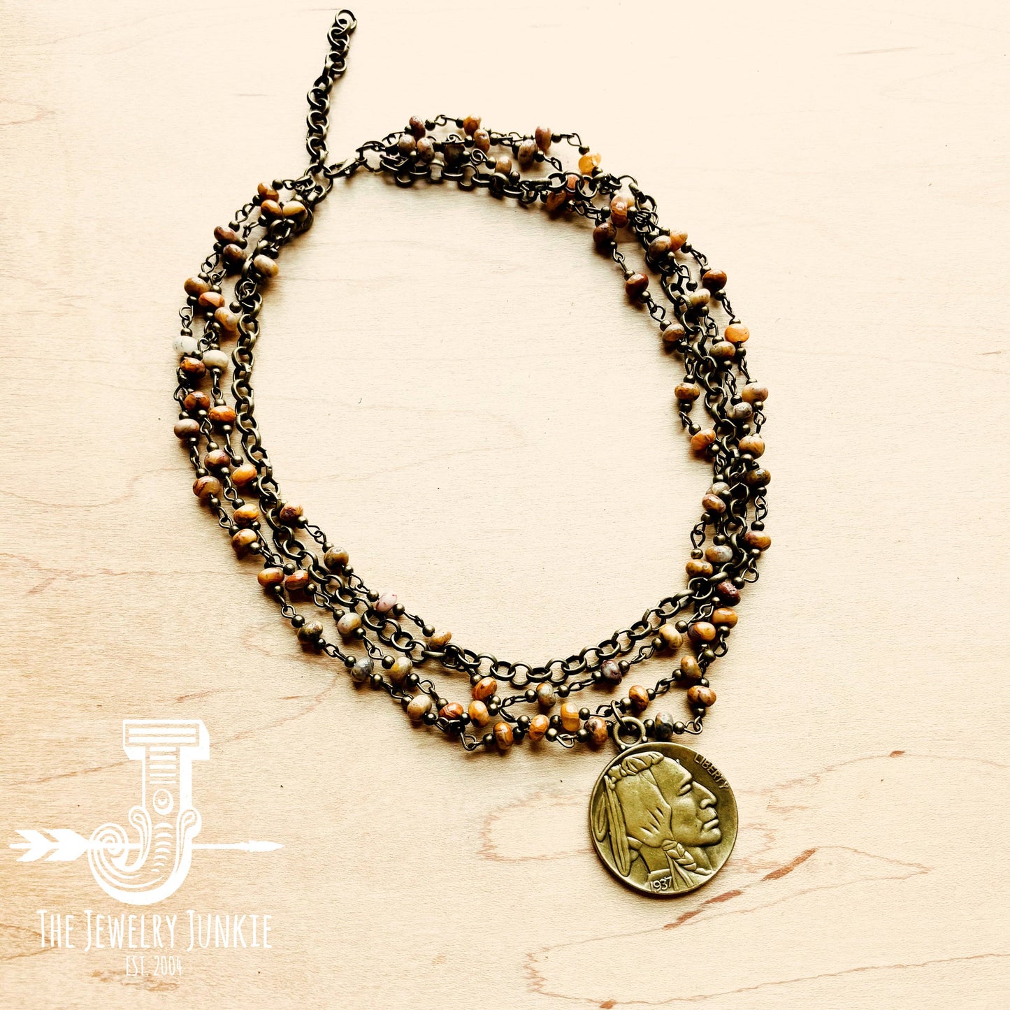 Necklace with coin pendant and beaded strands.