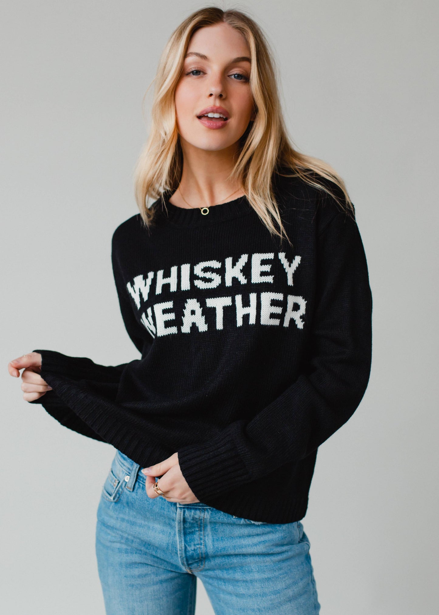 Woman in black Whiskey Weather sweater.