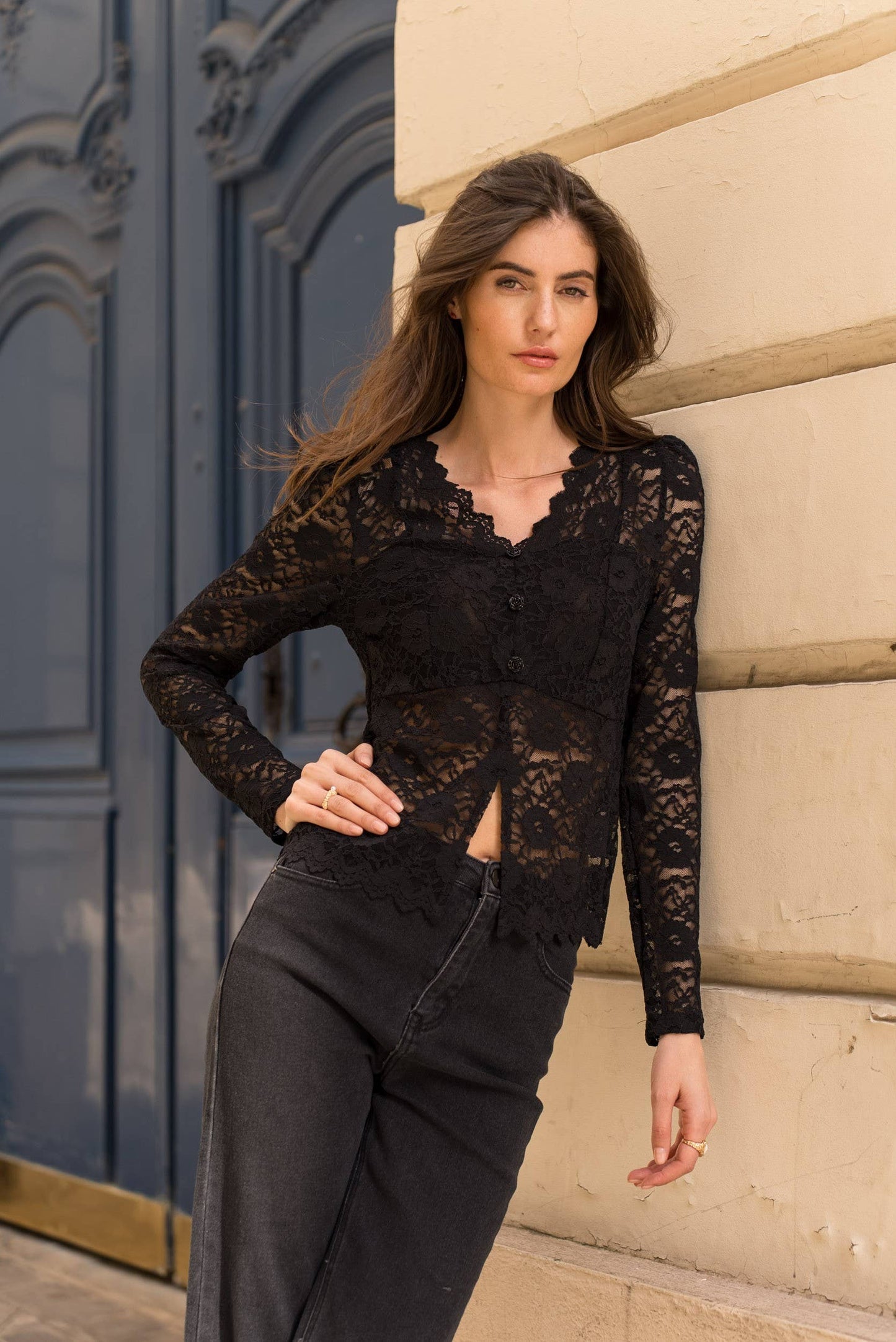 Woman wearing black lace top and jeans