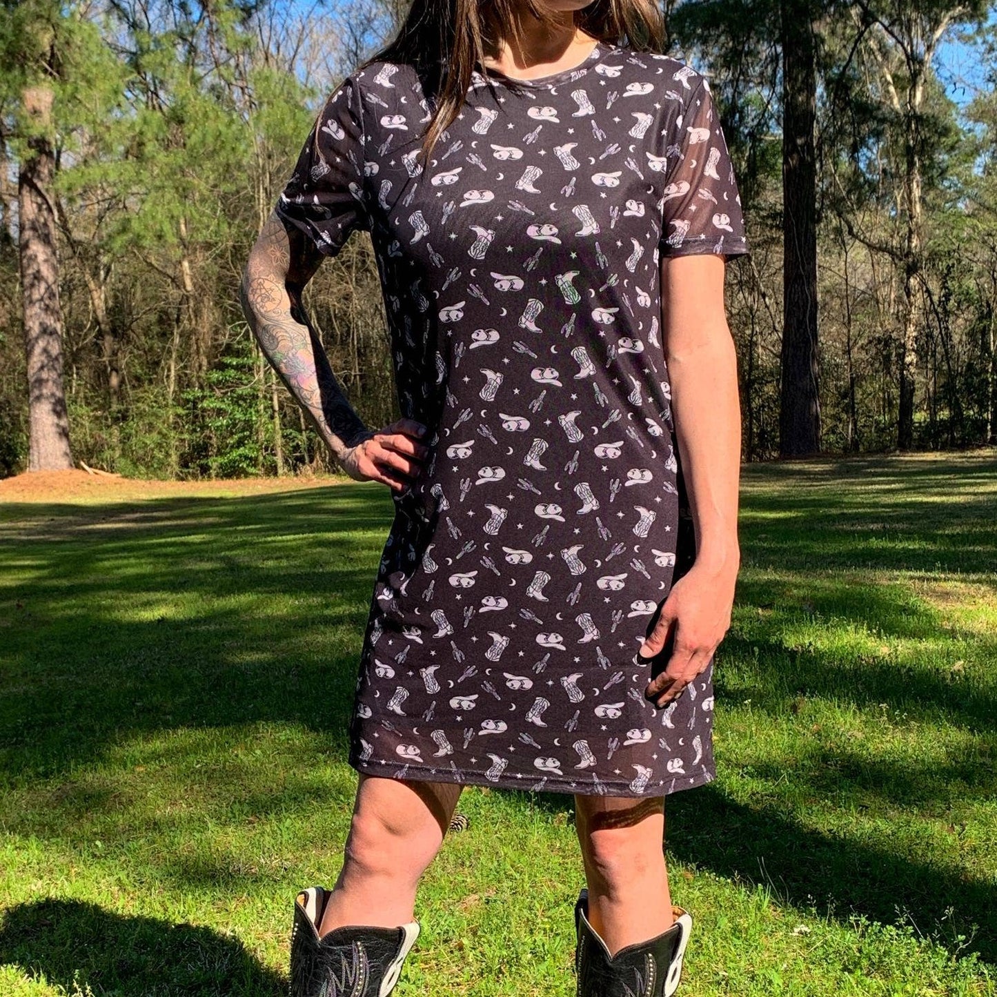 Woman in patterned dress and boots.