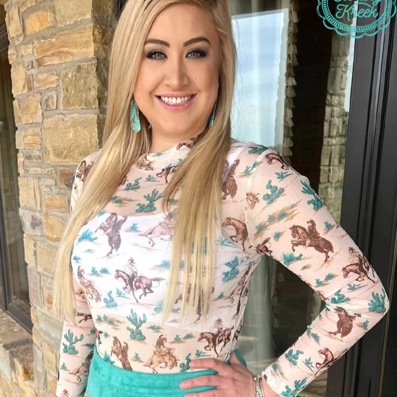 Woman wearing western print top