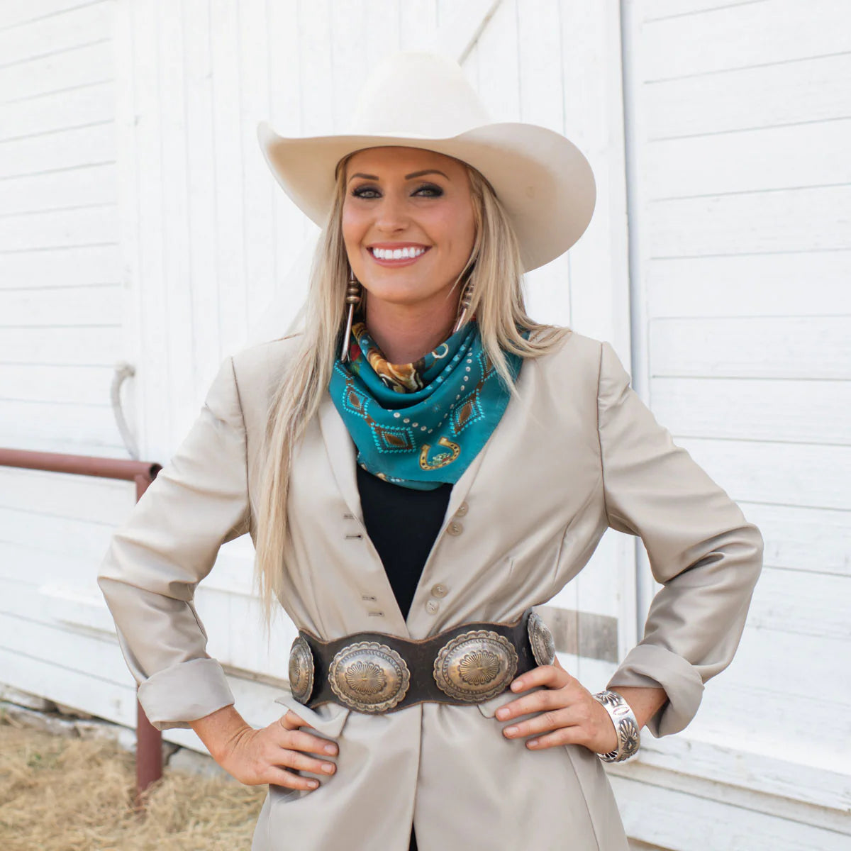 Woman wearing fringe scarf & cowboy hat with vintage horse design