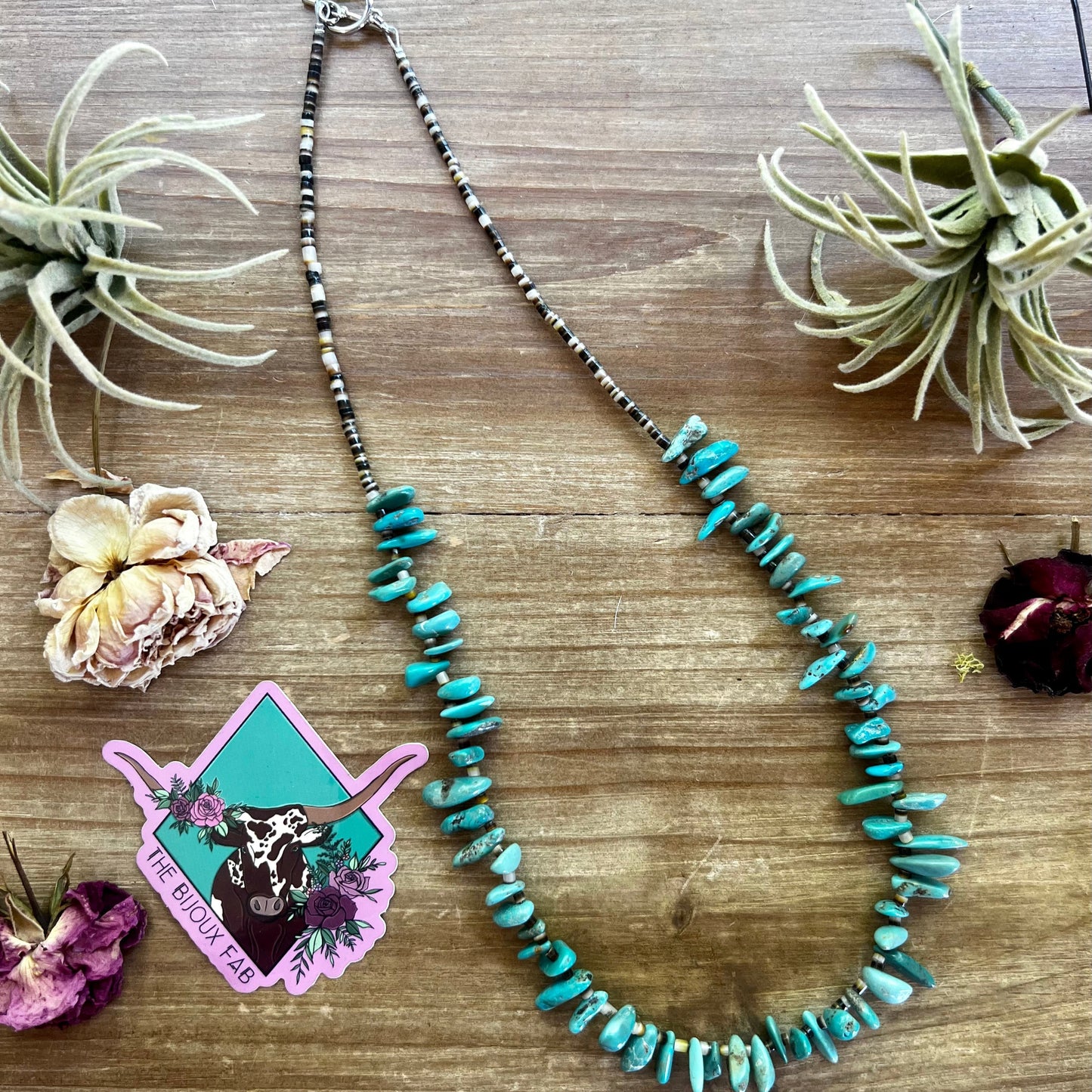Turquoise stone necklace on wood table