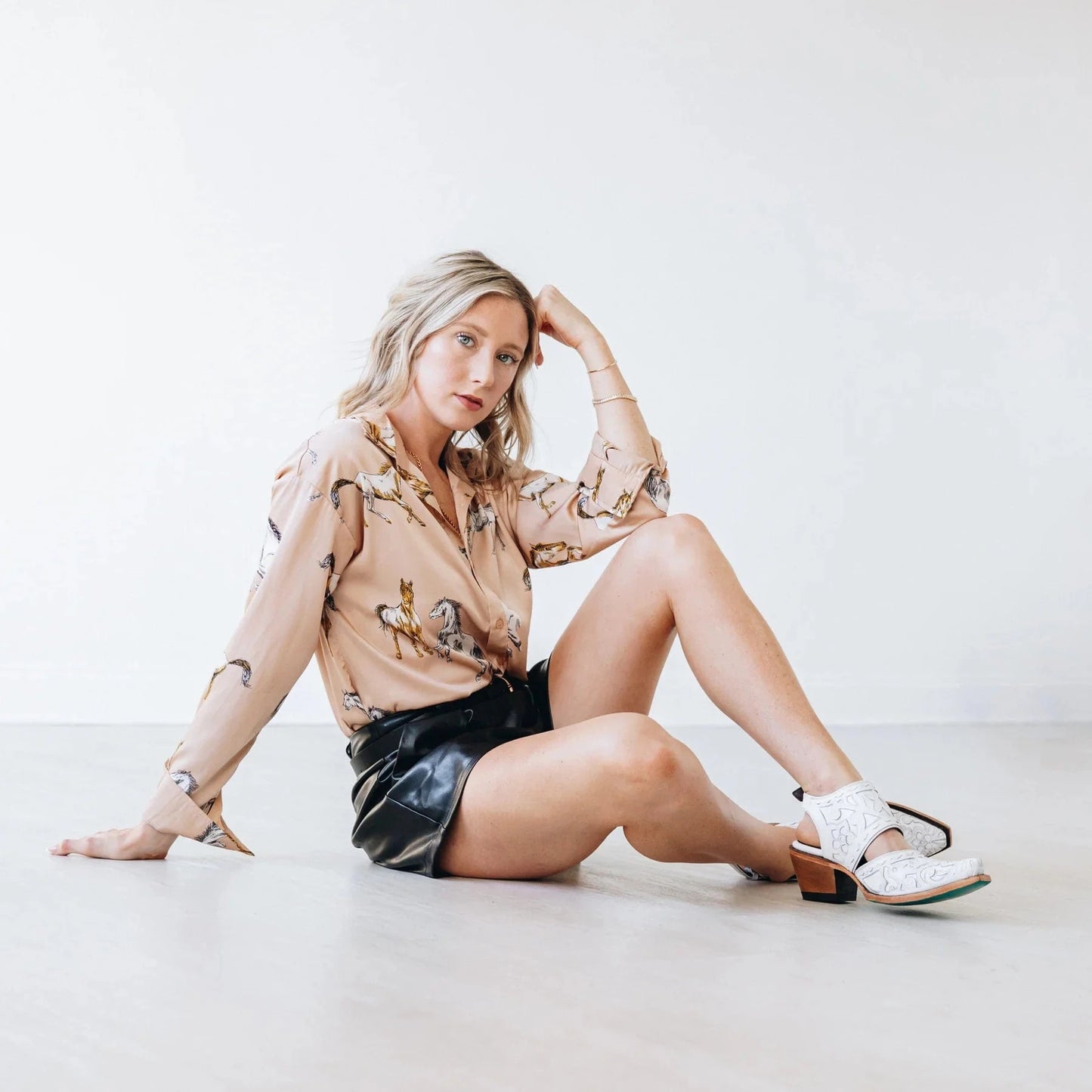 Woman wearing Robin Mule top & leather shorts