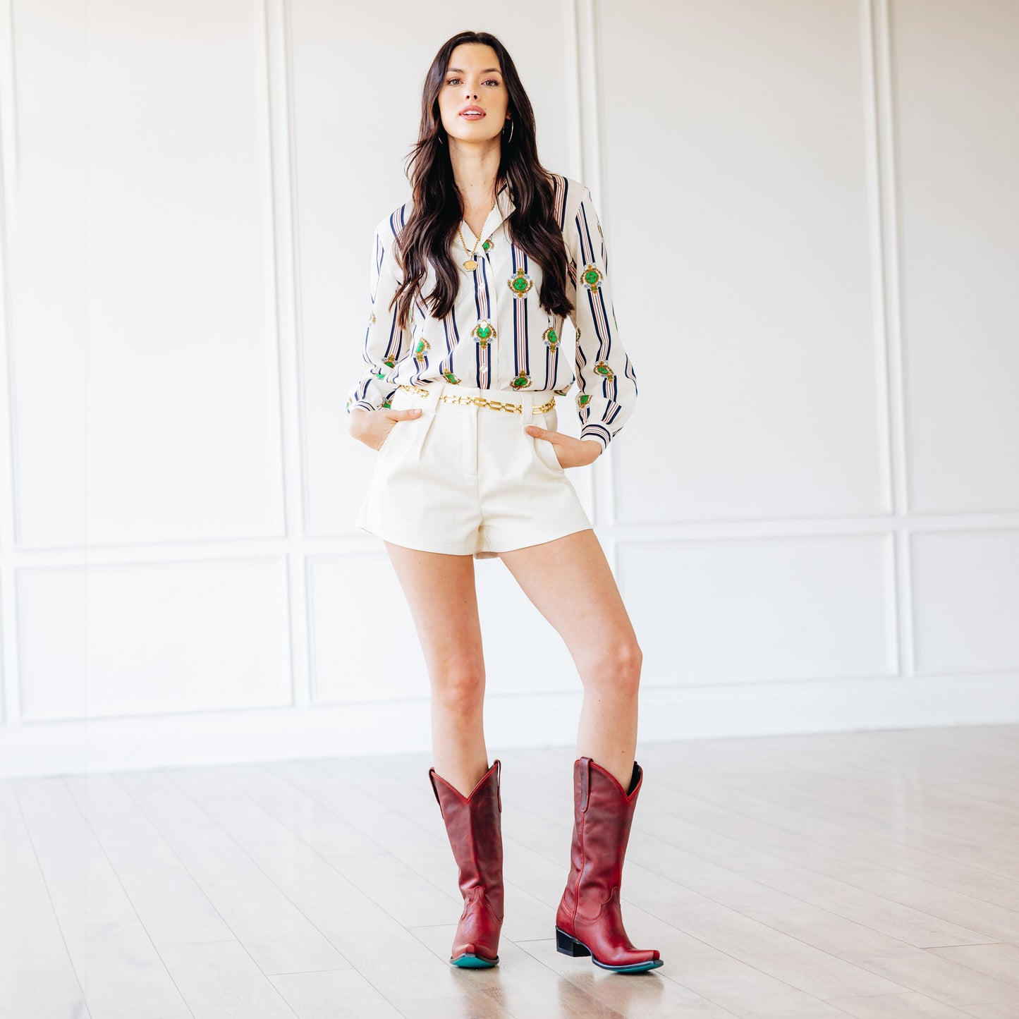 Emma Jane in Smoldering Ruby boots and white shorts.
