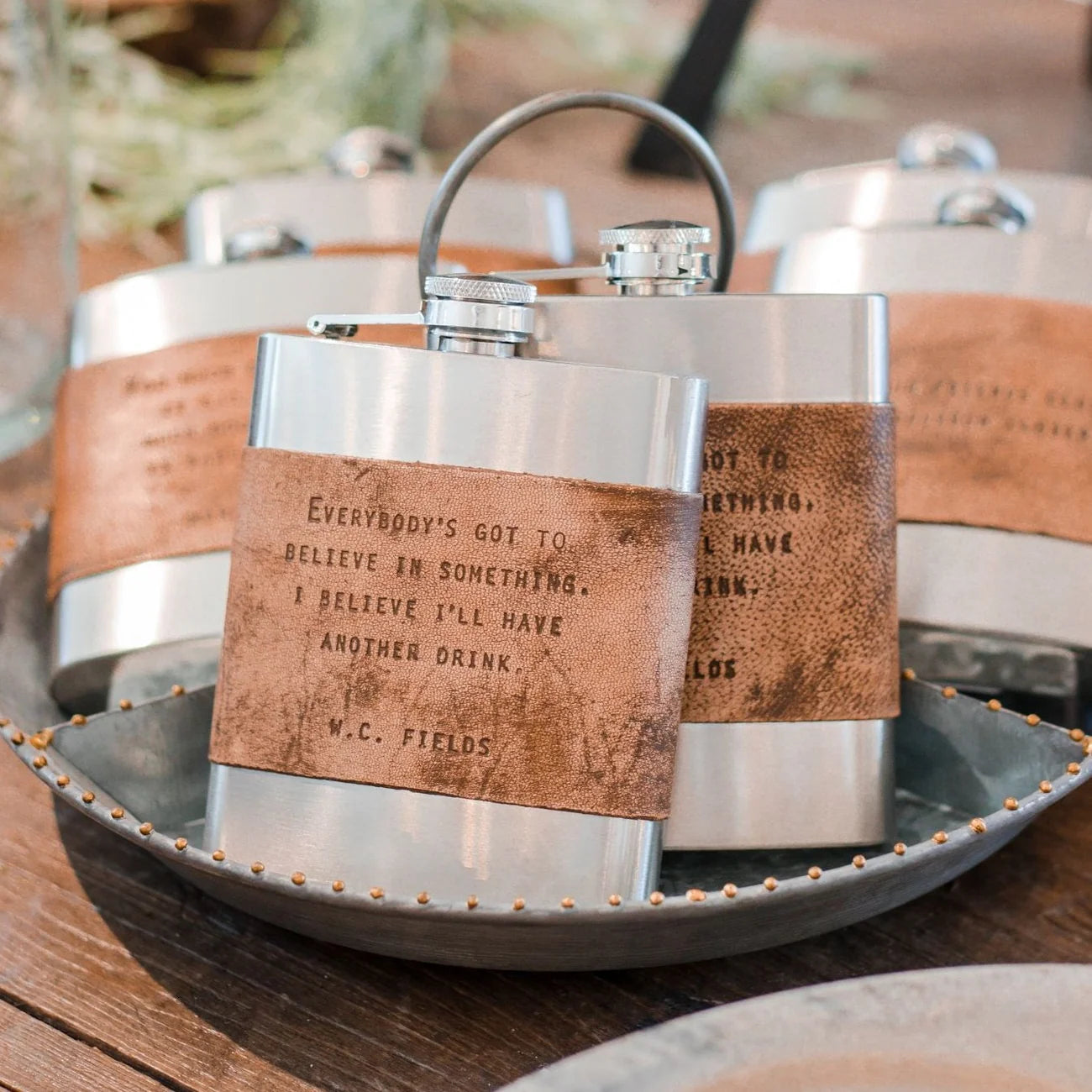 Stainless steel flask with quote on a tray