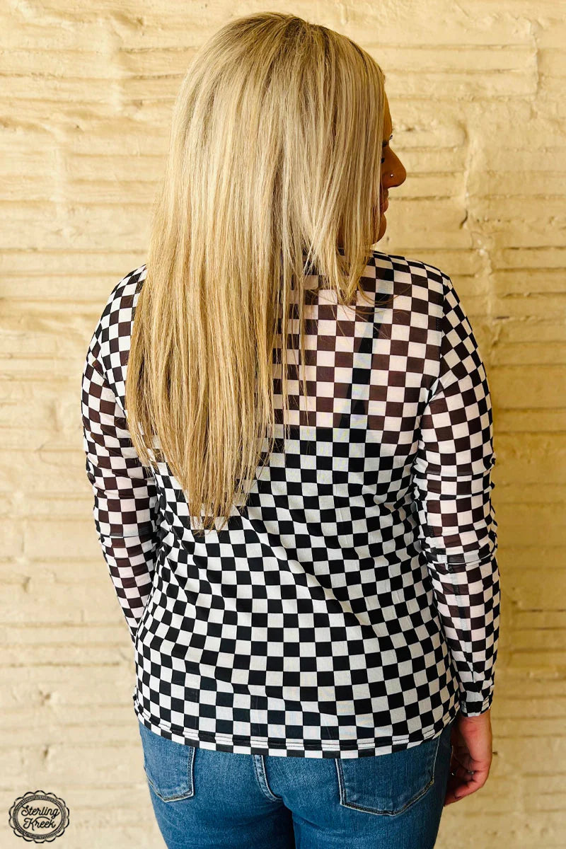 Woman wearing a checkered top, round the track style
