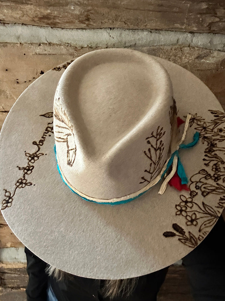 Tan hat with floral design