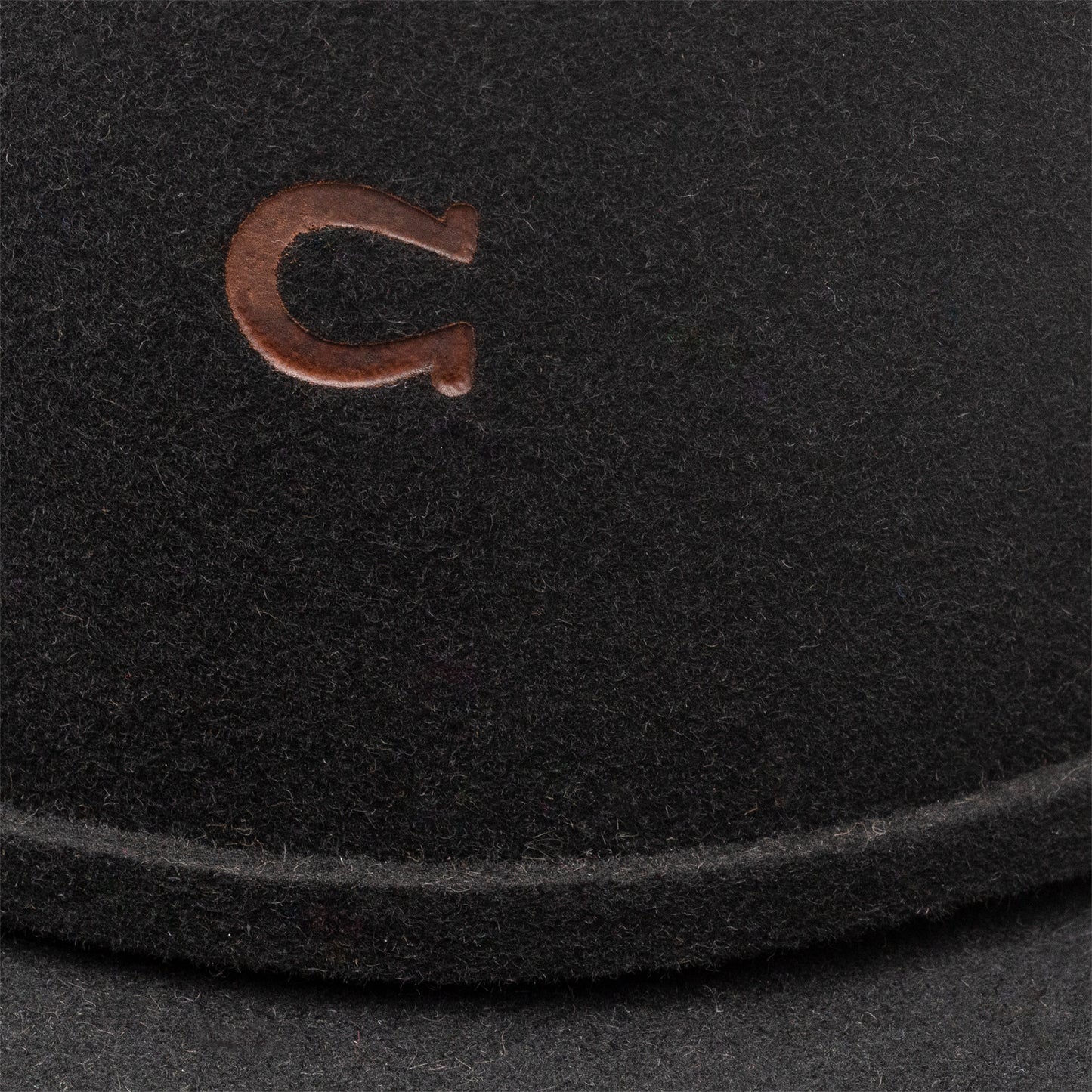 Black hat with brown horseshoe emblem