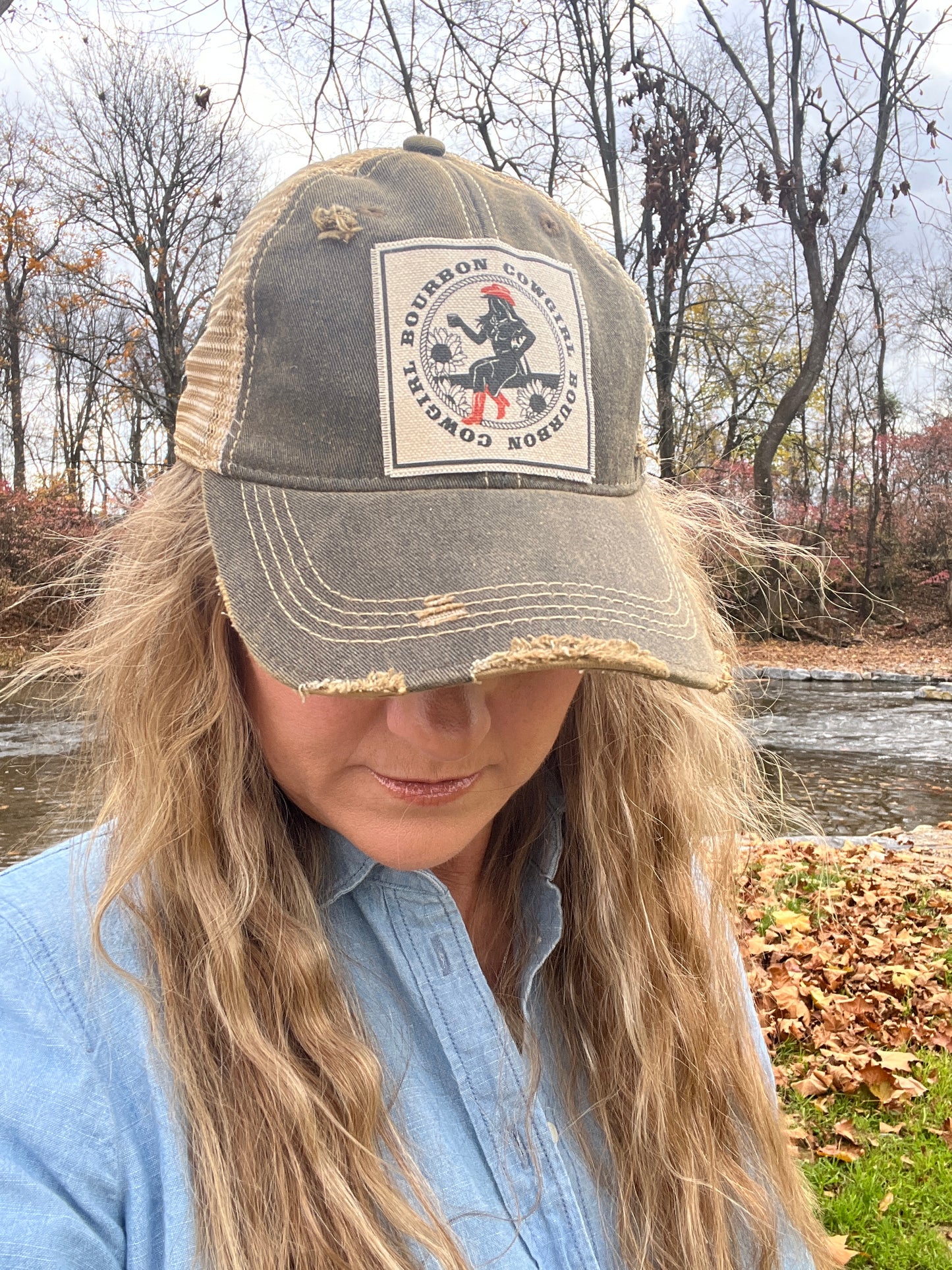 Woman wearing a baseball cap with a patch.