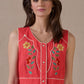 Woman in red In The Wings dress with floral embroidery