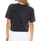 Woman wearing a black t-shirt and white shorts.