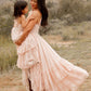 Woman holding a child, both wearing pink dresses.