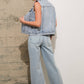 Woman in denim vest and jeans.