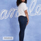 Woman in jeans and a white shirt smiling.