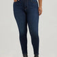 Woman in dark blue jeans and black boots.