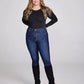 Woman in black shirt, jeans, and boots.