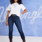 Woman in jeans, t-shirt, and boots.