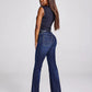 Woman in dark top and blue jeans.