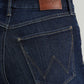 Close-up of dark blue Wrangler jeans with back pocket.