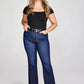 Woman in black top and blue jeans.