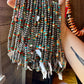 Hand holding turquoise & silver beaded necklaces, 12EBC273-ABF0