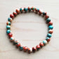 Beaded bracelet with red, blue, and white beads.