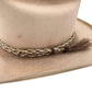 Tan cowboy hat with decorative band and tassel.