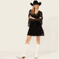 Woman in black lace dress, cowboy hat, and white boots.