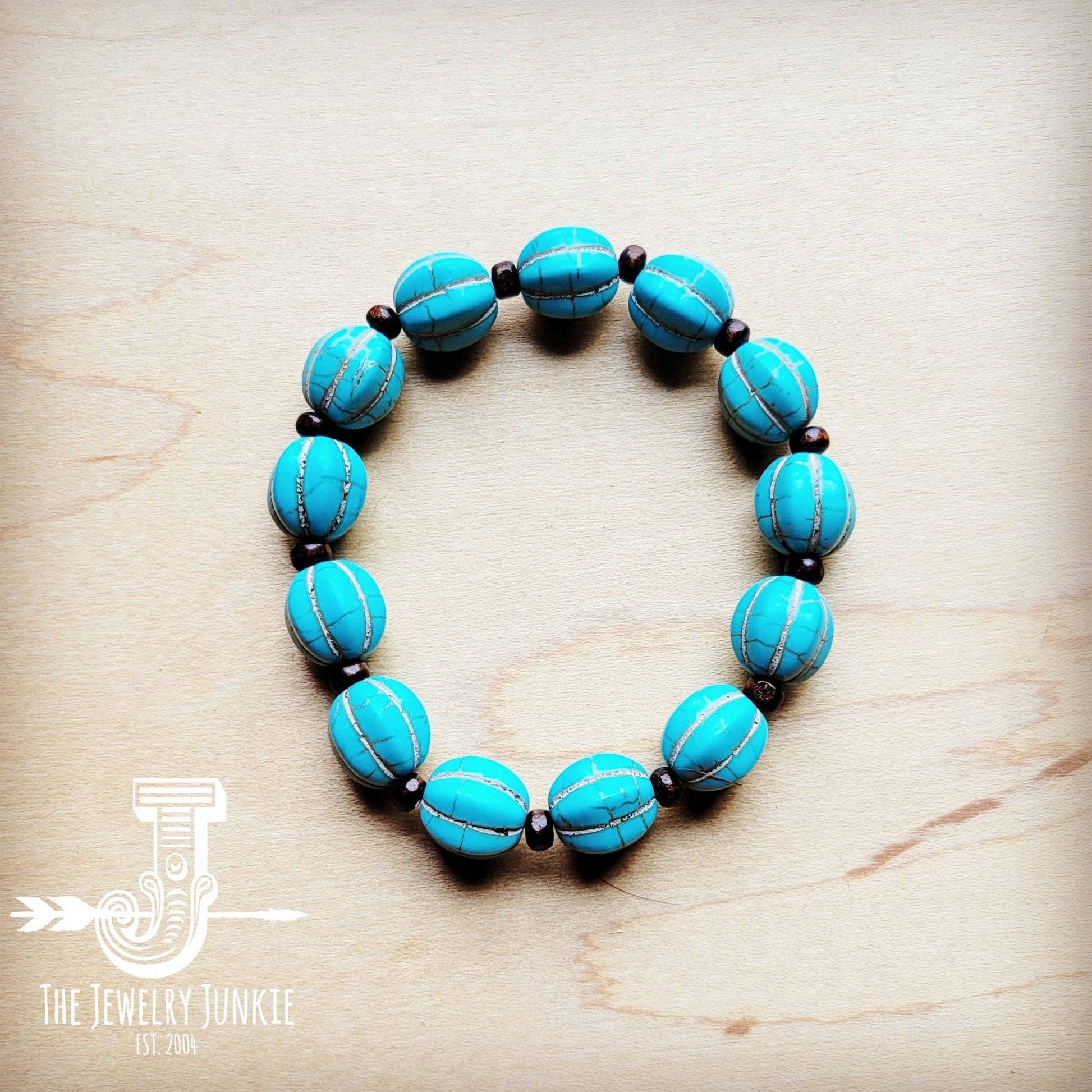 Turquoise beaded bracelet on wood surface.