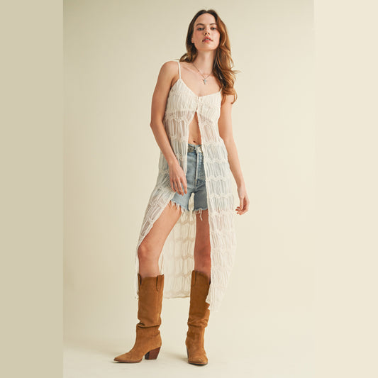 Woman wearing dress, shorts, and boots.
