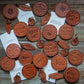 Leather coasters and keychains with text.