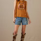 Woman in Stirrup Social Club top & boots, 1980s fashion.