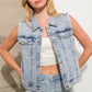 Woman in denim vest and jeans.