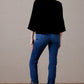 Daughter of the Moon top, woman in black cape & jeans