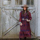 Woman in patterned dress & hat