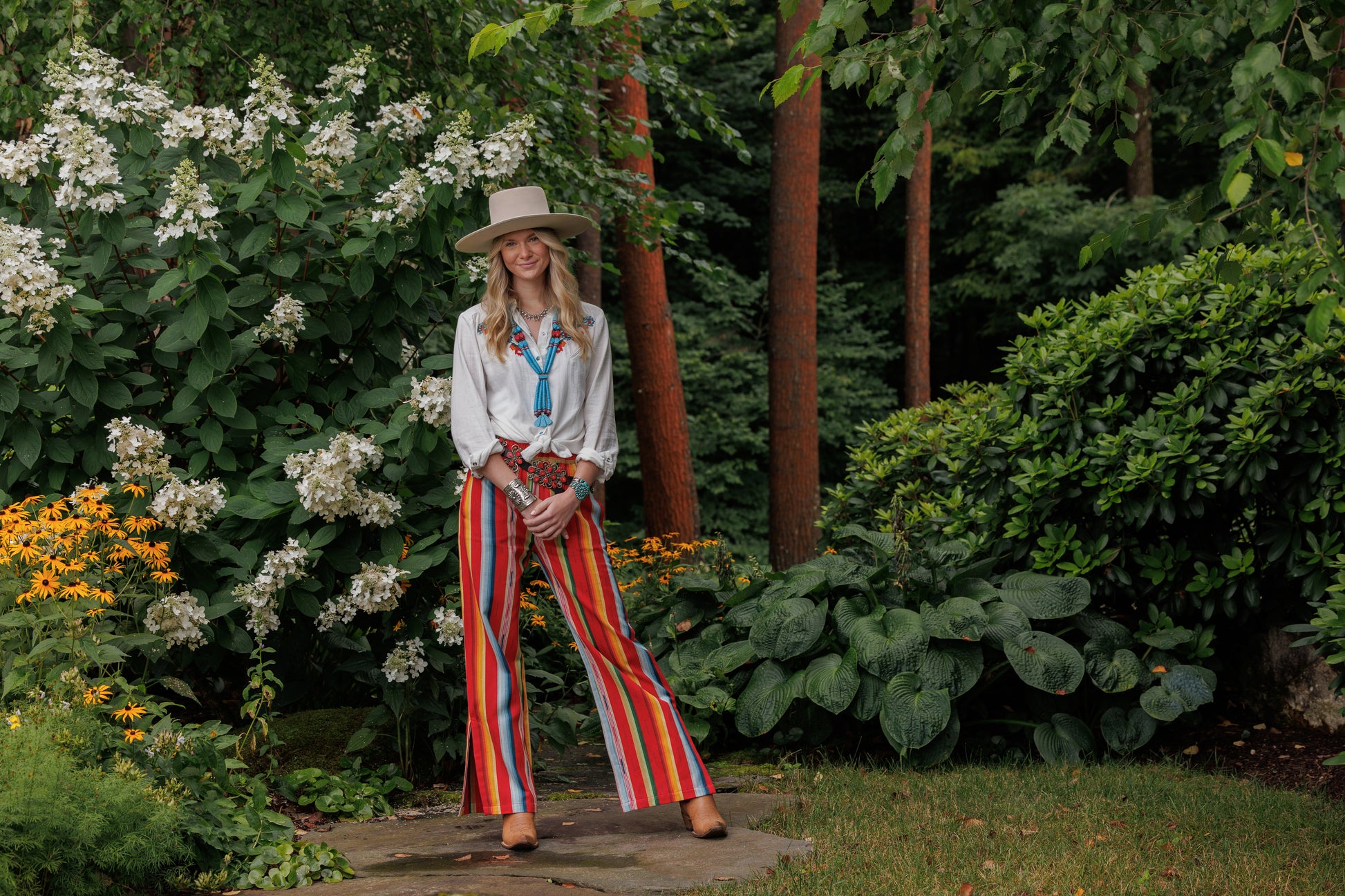 Woman in Winnie shirt and Lyla pants in garden