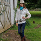 Cowgirl in white shirt, jeans, and cowboy boots.