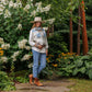 Woman in Virginia shirt and hat in garden