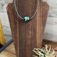 Turquoise bead necklace on display - 3FF793D9-0E07-46D7