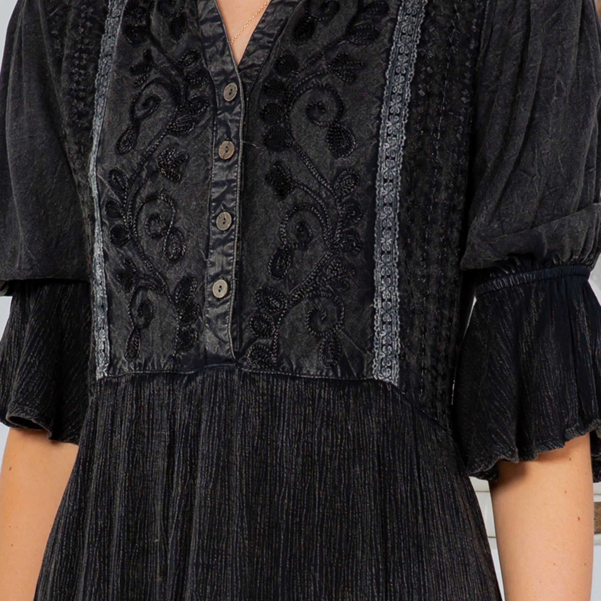 Black dress with floral embroidery.