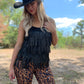 Woman in black fringe top and leopard pants
