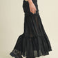 Woman in black skirt and boots.