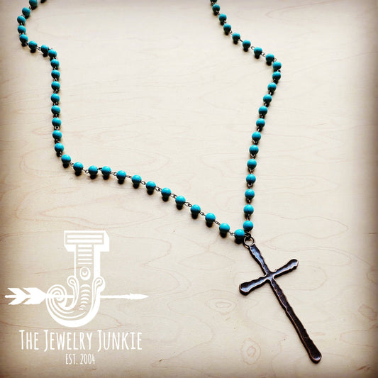 Turquoise beaded necklace with a cross pendant.