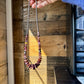 Hand holding a beaded necklace, 482E8851-ED8C-463F-A7A3-58B493F2B793