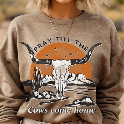 Woman wearing a sweatshirt with a bull skull graphic.