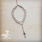 Pearl bead necklace with cross pendant.