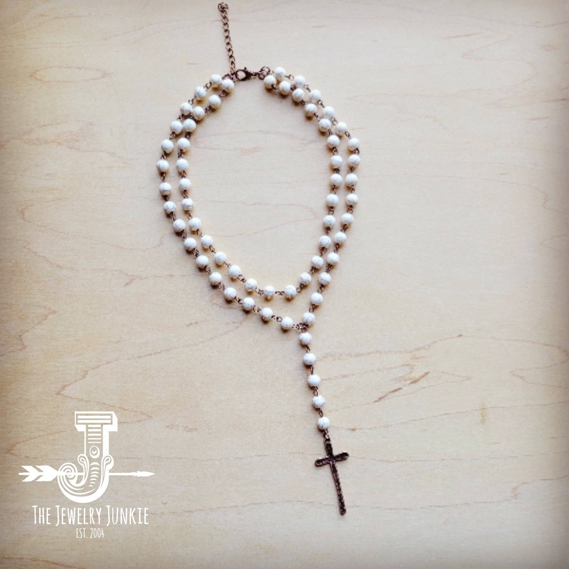 Pearl bead necklace with cross pendant.