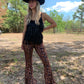 Woman in leopard print pants and fringe top.